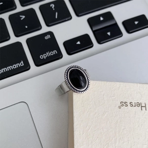 Macro shot of retro S925 sterling silver ring featuring a large oval black agate stone