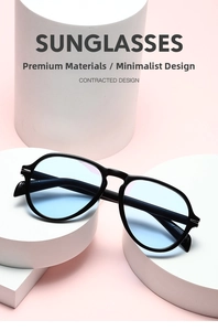 Detail of retro oversized sunglasses with light blue lenses and silver metal hinges
