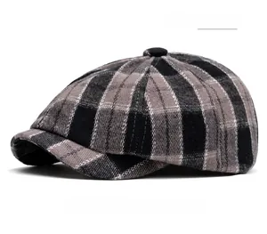 Close-up of grey grid newsboy cap showing detailed wool blend texture and pattern