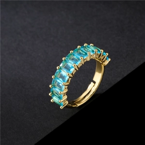 Adjustable gold plated open ring featuring blue rectangular baguette cut zircon stones