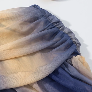 Detail of gradient mesh fabric showing breathable texture and vibrant yellow to purple hues