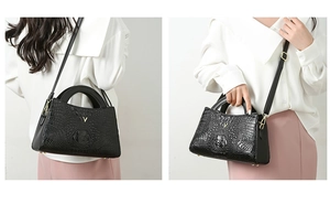 Detail of black crocodile texture handbag with golden V-logo and versatile strap