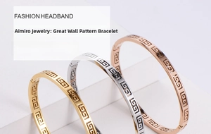 Detail of three stackable gold, silver, and rose gold bangles with Greek key pattern