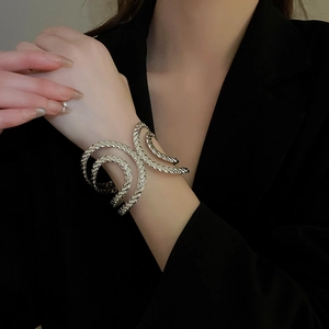 Close-up of a silver multi-layered rope textured open cuff bracelet on a model wrist