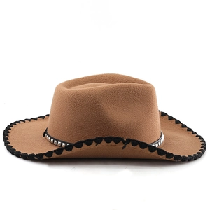 Detail of brown western cowboy hat with studded band and black stitched edge