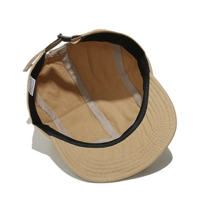 Detail view of khaki 5-panel camper hat interior with sweatband and adjustable buckle