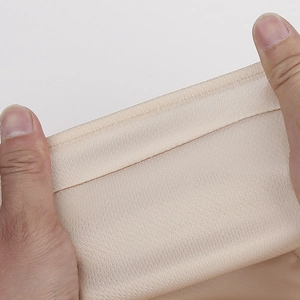 Detail showing the high elasticity and fine stitching of skin-tone breathable fabric