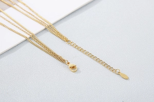 Detail view of gold-plated stainless steel necklace with lobster clasp and extender