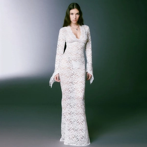 Detail of white lace maxi dress featuring deep V-neckline and elegant flared cuffs
