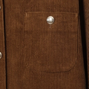 Brown oversized corduroy long sleeve jacket with metal buttons and chest pocket texture