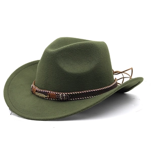 Detail of dark green felt cowboy hat with braided brown band and golden feather pin