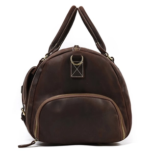 Macro view of vintage brown crazy horse leather weekend bag with side pocket and handle