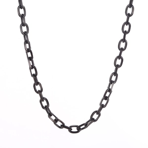 Detail shot of a black stainless steel cross chain necklace with textured oval links