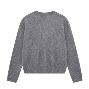 Detail view of the gray knit sweater back showing ribbed hem and soft wool texture