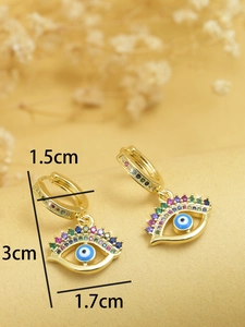 Macro shot of evil eye palm earrings showing 3cm length and 1.5cm hoop diameter