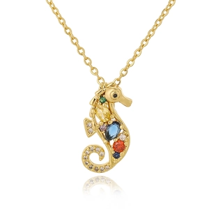 Macro shot of gold seahorse pendant featuring vibrant multi-colored gemstone settings