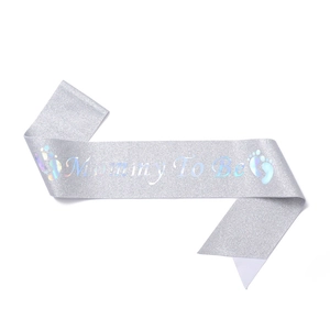 Detail of silver glitter Mommy To Be sash with baby footprints for baby shower parties