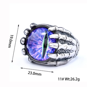 Detailed macro view of punk stainless steel claw ring with a purple evil eye stone