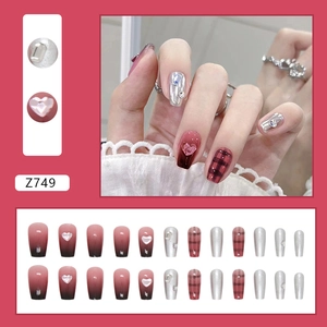 Red and black gradient press-on nails with silver metallic accents and rhinestone hearts