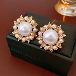Gros plan de boucles d'oreilles tournesol vintage avec perles et cristaux fins