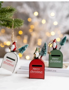Detailed close-up of iron Christmas mailbox hanging ornaments in red, white and green
