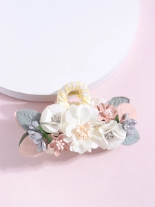 Detail of fabric flower hair claw with faux pearls, rhinestones, and striped fabric handle