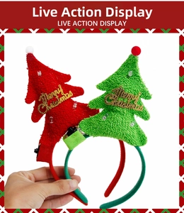 Detail of LED light switch and battery pack on plush Christmas tree headband