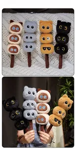 Detailed close-up of cute cat plush skewers with embroidered faces and soft plush texture