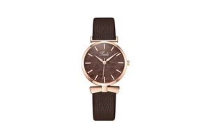 Close-up of a rose gold fashion watch featuring a dark brown dial with leaf pattern