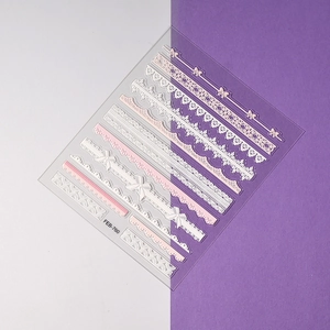 Detail of pink and white lace 3D embossed nail stickers with floral and bow patterns