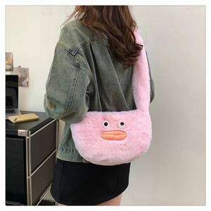 Detailed view of pink plush crossbody bag featuring funny cartoon face and orange lips