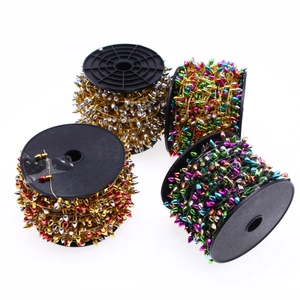 Detail of four metallic bead chain spools in gold and silver for Christmas tree decor