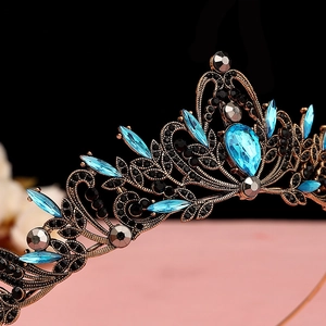 Detail of baroque black crown featuring blue water-drop rhinestones and vintage bronze finish