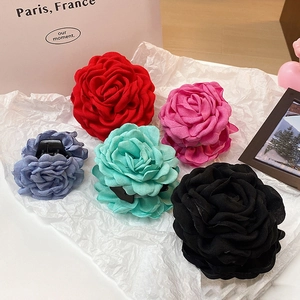 Detailed macro view of assorted fabric rose hair claws in various vibrant colors