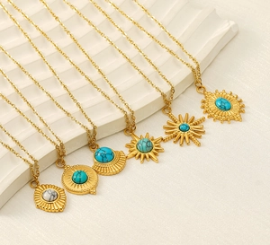 Detail of 18K gold stainless steel necklaces with turquoise and starburst pendants