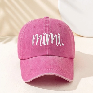Close-up of pink washed cotton baseball cap featuring mimi white letter embroidery detail
