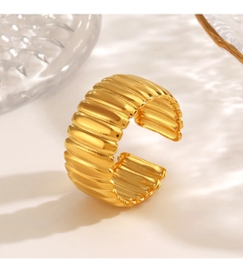 Macro shot of 18K gold plated croissant dome ring with a polished textured finish