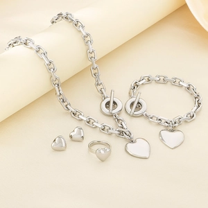 Close-up of silver stainless steel heart jewelry set with chunky chain and OT clasp detail