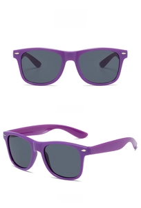Close-up of purple retro sunglasses with grey lenses and stylish metal rivets