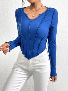 Slim fit bright blue ribbed knit long sleeve tee with exposed seams and U-neckline