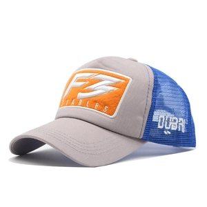 Detail view of mesh trucker hat with orange F3 felt patch and white Dubai embroidery