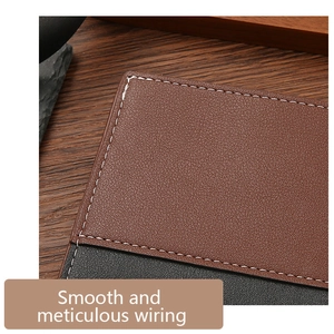 Macro shot of bicolour leather wallet stitching and meticulous texture on wood base