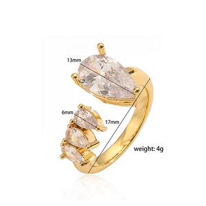 Detailed view of gold cross ring featuring a 13mm pear-cut cubic zirconia stone
