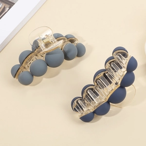 Matte bead shark hair clips in blue and navy tones on minimalist cream background