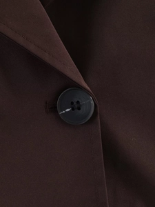 Detail of dark brown twill fabric with marble pattern double-breasted button and stitching