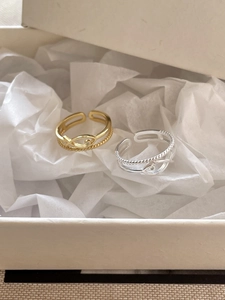 Detail of gold and silver fish-shaped rings with fine diamonds in a gift box