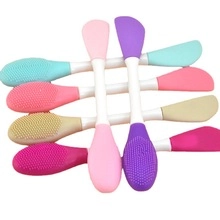 Dual-sided silicone facial cleansing brush and mask applicator in vibrant pastel colors