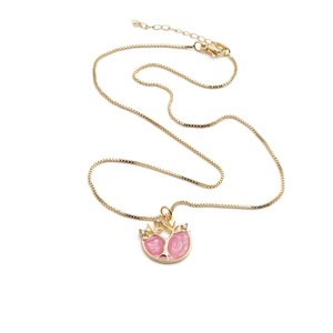 Gold plated tree pendant necklace with pink enamel and small crystals on a box chain
