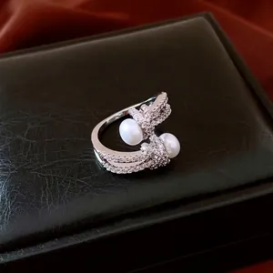 French style silver knot ring with two pearls and pavé zircons on luxury black leather