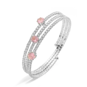 Detail of silver multi-layer bracelet with sparkling zircons and pink round gemstones